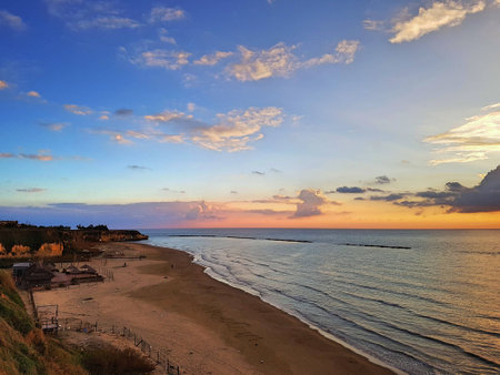 Beach and sea at dusk with colorful clouds.の写真素材