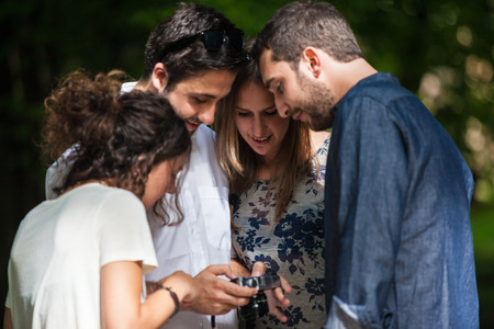 Friends Sharing a Moment Trough a Mobile Phoneの写真素材