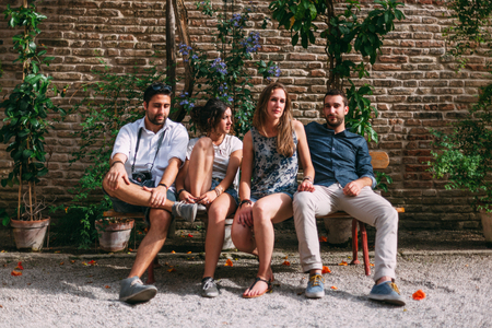 Four Friends Sitting Under an in Blossom Tree