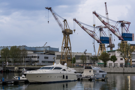 Port channel with boat ancd cranesの写真素材