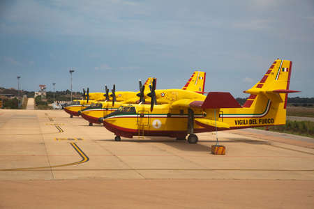 vigili del fuoco - italian extinguisher airplanes standing on airport runway in parking position...