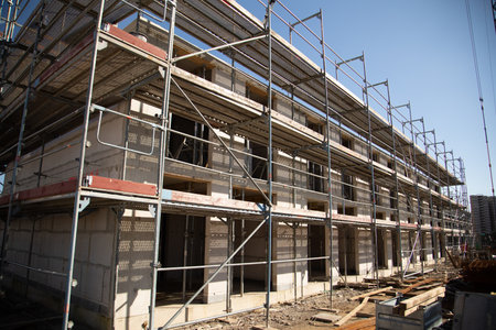 build a new house out of concrete with scaffolding next to the walls to get access to every level of...