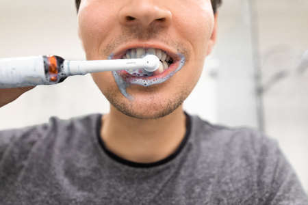 After brushing his teeth the foam of toothpaste left on his mouthの写真素材