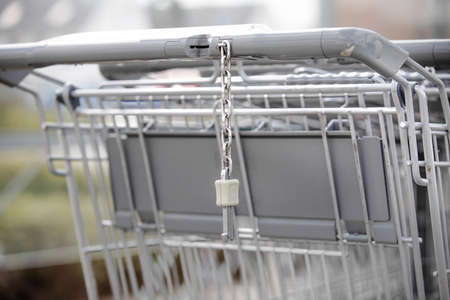 chain connector on a shopping cart hang on grip next to coin slot is a mechanism you have to insert...