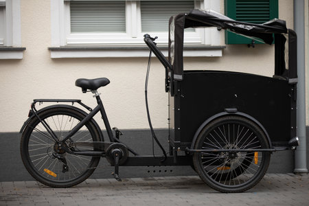 carrier cycle parking on street next to house waiting to get packed with heavy loads to be carried...