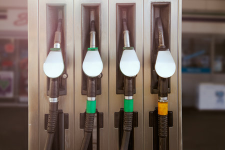 Pump gas station with full nozzles to refill tank of car with gasoline and gasoline mockup