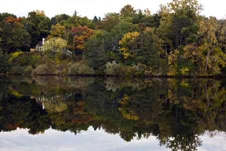 Reflection of autumn trees in the Huron River on a beautiful fall dayの写真素材