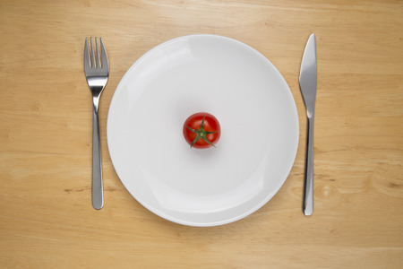 Tomato in center of plateの写真素材