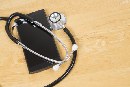 Doctors stethoscope arounds a black modern smart phoneの写真素材