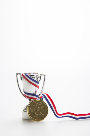 Gold medal with a silver trophy on a white backgroundの写真素材