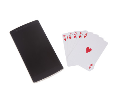 Poker cards layed out as Royal flush next to smart phoneの写真素材