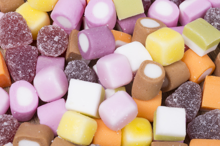 Background texture of assorted colorful chewy candy in a concept of childhood treats and unhealthy diet rich in sugar and caloriesの写真素材