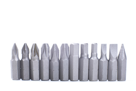 Bottom border of assorted bits or heads for an interchangeable screwdriver isolated on white in a...
