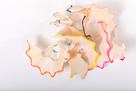 Shavings of color pencils close-up detail view from above on white backgroundの写真素材