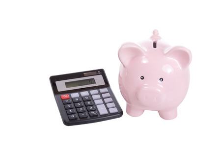 Ceramic pink piggy bank and simple calculator side by side isolated on white in a financial, investment or savings conceptの写真素材