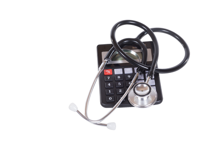 Calculator with stethoscope viewed from above isolated on white in a concept of the cost of medicine and hospitalisationの写真素材