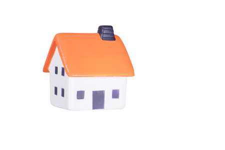 Isolated small toy model of a house with a colorful red roof for use as a design element with copy spaceの写真素材