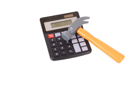 Small yellow hammer with a calculator on white in a DIY, renovations and home improvements concept with copy spaceの写真素材