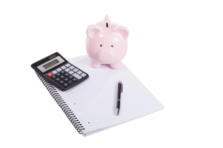 Business meeting, savings, accounting, planning or education concept with a blank notebook and pen isolated on white with a calculator and piggy bankの写真素材