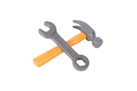Crossed isolated hammer and spanner on white in a DIY, renovations and home improvements concept with copy spaceの写真素材