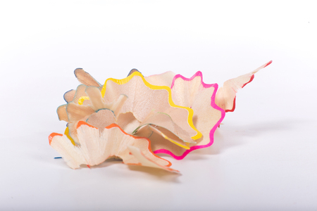 Shavings of color pencils close-up detail view on white backgroundの写真素材