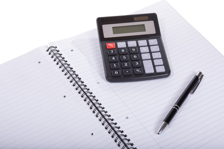 Blank spiral bound notebook with pen and calculator in a close up view conceptual of business accounting, planning or analysis of of college educationの写真素材