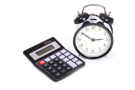 Classic black alarm clock with white face and simple old black calculator viewed from high angle isolated on white background with copy space. Counting time conceptの写真素材