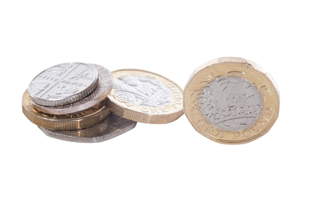 Isolated pile of the new British pound coin showing the design of the engraving in a financial conceptの写真素材