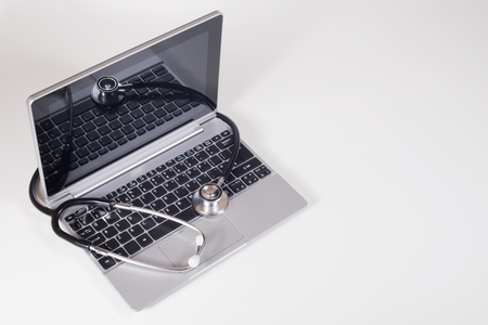 Stethoscope on a laptop computer in a concept of online medicine or troubleshooting the notebook viewed high angle with copy spaceの写真素材
