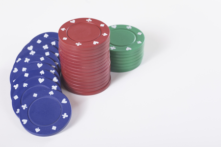 Three stacks of gambling chips against white backgroundの写真素材