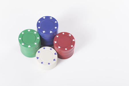 four stacks of different colored casino chips for placing bets on the tables and roulette isolated...