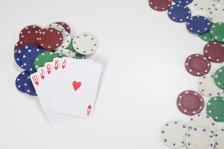 Top down view on pile of cards and red, blue, green and white poker chips with copy space