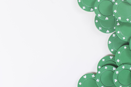 Side border of green casino gambling chips isolated on white viewed from above with copy spaceの写真素材