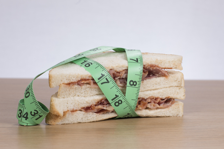 Sandwich with meat wrapped in measuring tapeの写真素材