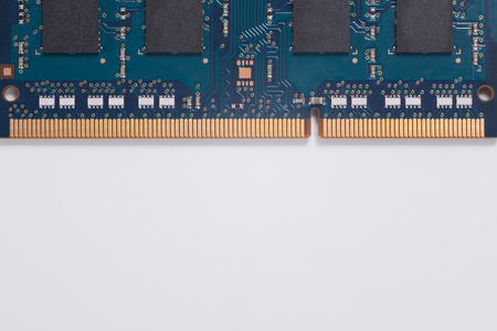 Close up detail of the circuits on a memory chip for a laptop computer over white forming a top...