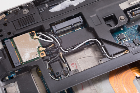 A close up of the internal electrical wiring, parts and components of a computer laptop.の写真素材