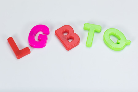 LGBTQ written with colourful kids alphabet learning letters on a plain white background with copy space.の写真素材