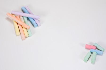 Old, discarded drawing chalk sticks and unused, new sticks in an old versus new conceptual theme...
