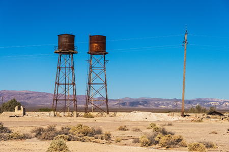 Rusty and weathered water tanks in Death Valley Junction, ancient railroad station in the Death Valley, California.の写真素材