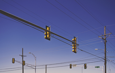 Traffic lights at a crossroad with a clear blue sky - with filter effect - USA.