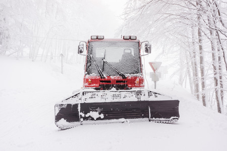 Front portrait of a snowy snow plow in winter in a foggy day - Vosges (France) - december 2017の写真素材