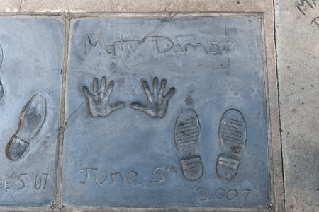 Handprints and footprints of the famous american actor Matt Damon on the ground behind TCL Grauman 's Chinese Theater, Hollywood Boulevard, Los Angeles, California.のeditorial素材