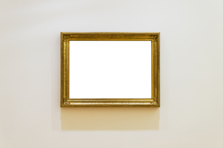 White clipped painting with a wooden carved frame hung on a clear wall.の写真素材