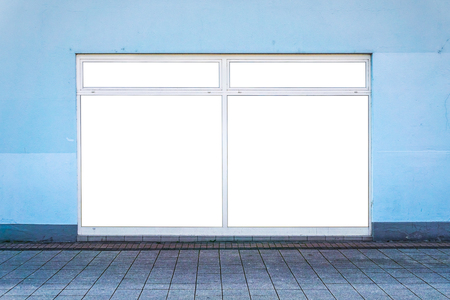 White clipped windows on a blue wall in the street. The clipped area replaces an existing advertisement. Commercial and advertising concept.の写真素材
