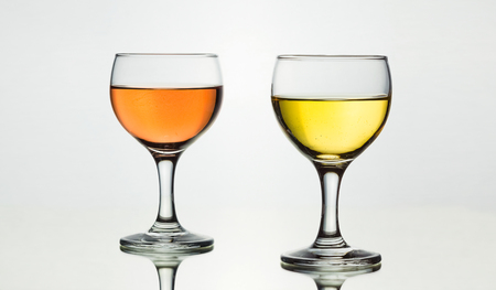 Two glasses full of french wine isolated on a white background with mirror reflection.の写真素材