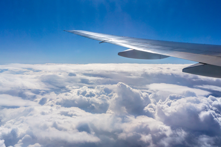 Flying above the sky. Shape of the airplane wing on a blue sky.の写真素材