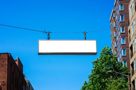 Blank street sign hanging over an avenue. Mockup and commercial concept.の写真素材
