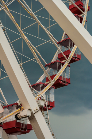 Detail of a Ferris Wheel with red gondolas, USA. Vertical.の写真素材
