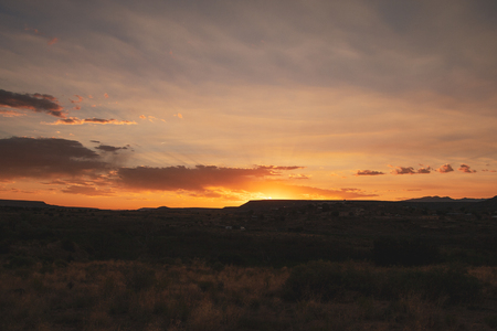 Beautiful vibrant countryside sunset over hillside in New Mexico along the US route 66, USA.の写真素材