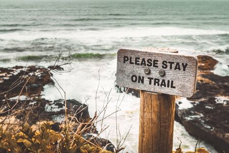 Please Stay on Trail wooden signpost along the Pacific Coast, Cape Perpetua, Yachats, Oregon, USA.の写真素材